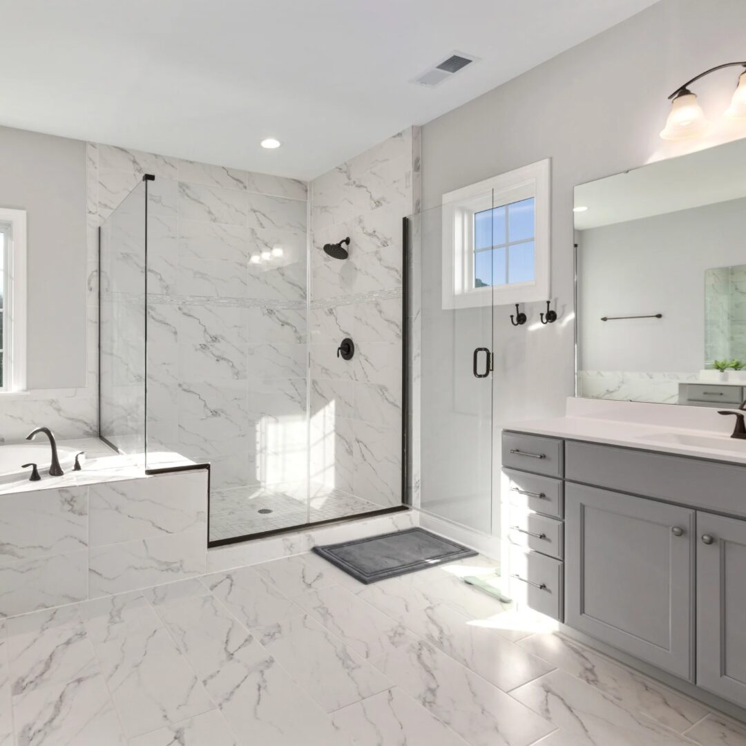 Master bathroom with marble tile, soaking tub and glass shower