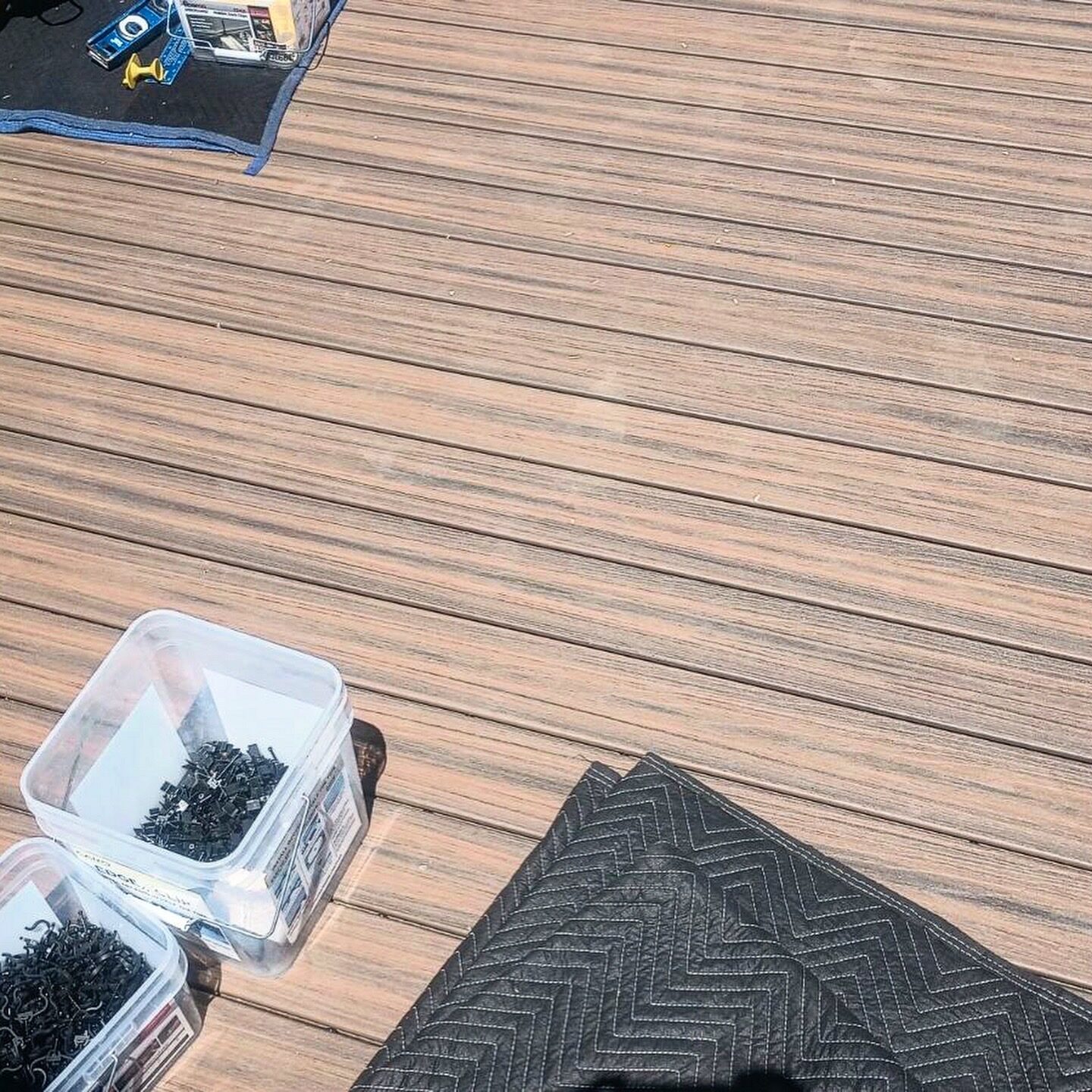 Composite decking boards going down over a waterproof membrane