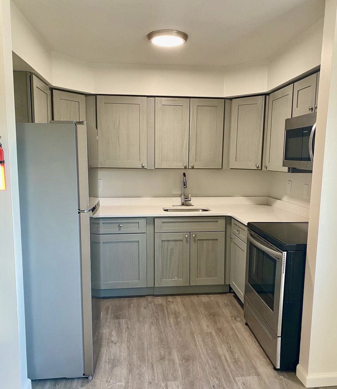 Remodeled kitchen with grey cabinets